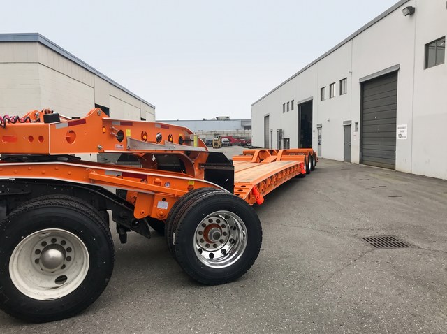 Close view of the orange gooseneck and frame running back along the wooden deck.