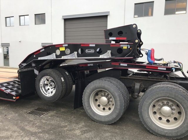 Close view of the black and red gooseneck, neck axle and tractor connection.