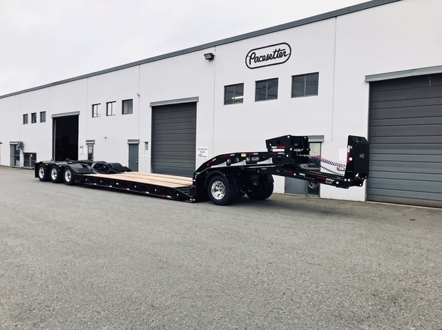 Front three-quarter view of the all-black lowbed standing unhitched in the Pacesetter yard.