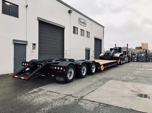 Rear three-quarter view of the all-black lowbed in the Pacesetter yard.