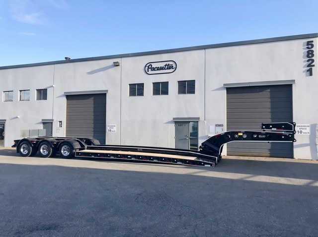 Full side profile of the black lowbed with white trim outside Pacesetter.