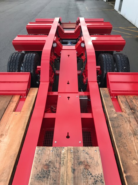 Top view of the all-red rear frame, folding ramps and wooden deck sections.