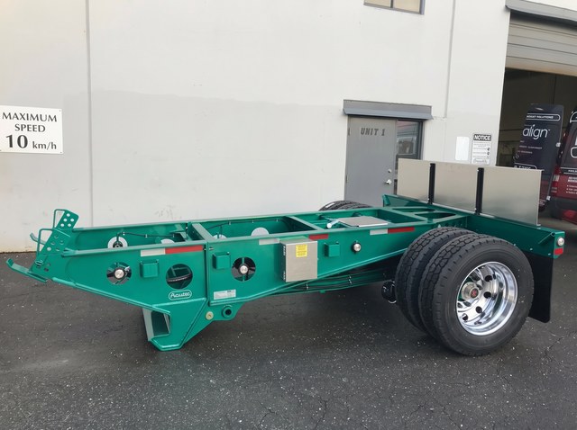 The green Fish Mouth booster with its coupling frame and single axle in Langley.
