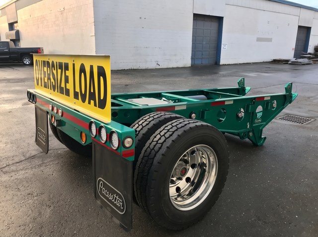 Rear three-quarter view of the green Fish Mouth booster, wheel and coupling frame.