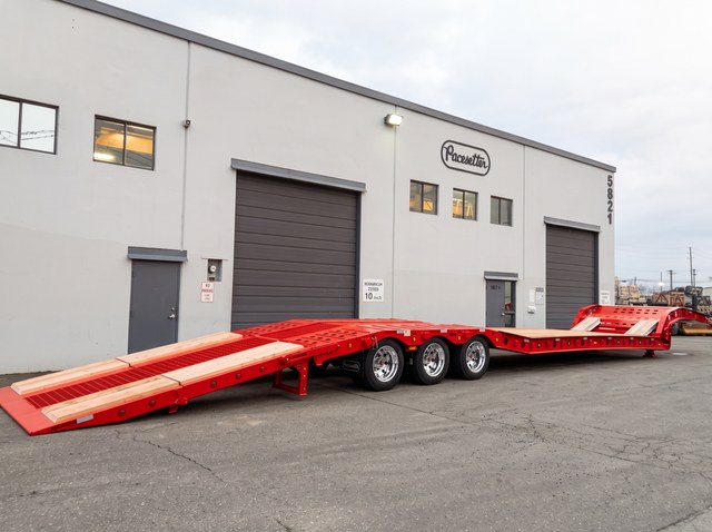 Red paving trailer with its rear loading ramp lowered in the Pacesetter yard.