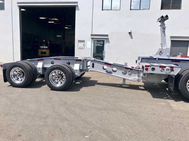 White pin-on booster assembly with blue pinstriping and polished wheels.