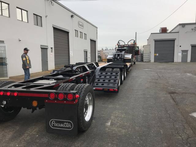 Black 55 ton lowbed with red pinstriping and a single axle pin-on booster at the Pacesetter yard, photo 2 of 14