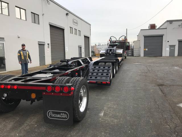 Black 55 ton lowbed with red pinstriping and a single axle pin-on booster at the Pacesetter yard, photo 3 of 14