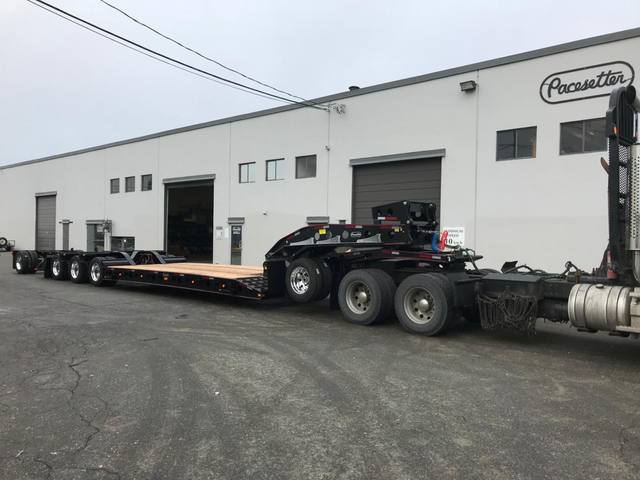 Black 55 ton lowbed with red pinstriping and a single axle pin-on booster at the Pacesetter yard, photo 9 of 14