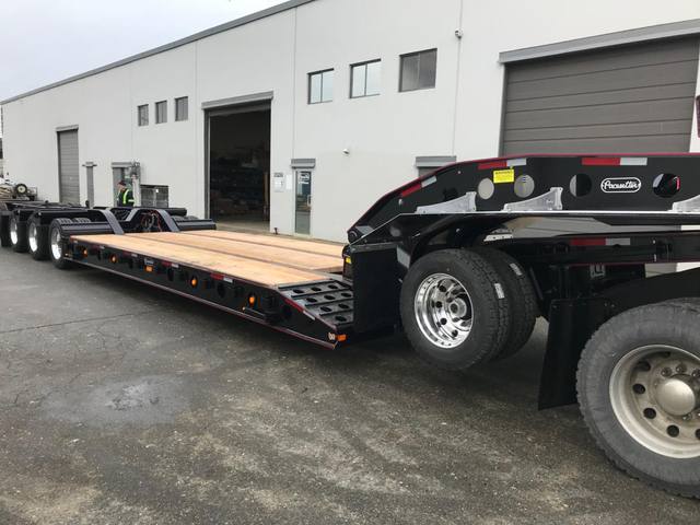 Black 55 ton lowbed with red pinstriping and a single axle pin-on booster at the Pacesetter yard, photo 11 of 14