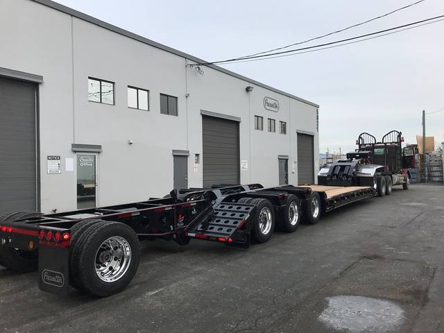 Black 55 ton lowbed with red pinstriping and a single axle pin-on booster at the Pacesetter yard, photo 13 of 14