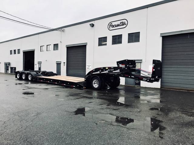 Black 60 ton lowbed with neck axle and tridem rear on a rainy day at the Pacesetter yard, photo 1 of 9