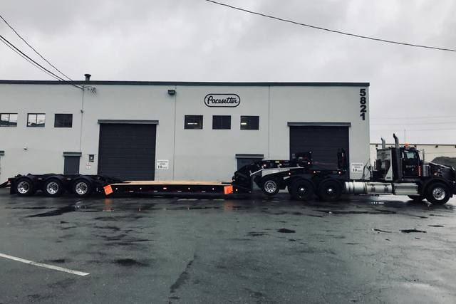 Black 60 ton lowbed with neck axle and tridem rear on a rainy day at the Pacesetter yard, photo 6 of 9
