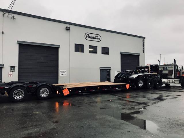Black 60 ton lowbed with neck axle and tridem rear on a rainy day at the Pacesetter yard, photo 7 of 9