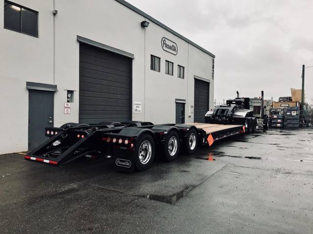 Black 60 ton lowbed with neck axle and tridem rear on a rainy day at the Pacesetter yard, photo 8 of 9