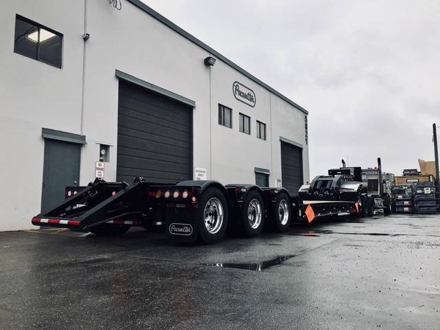 Black 60 ton lowbed with neck axle and tridem rear on a rainy day at the Pacesetter yard, photo 9 of 9