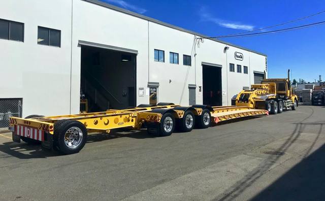 Yellow 60 ton lowbed with black fenders and a pin-on booster at the Pacesetter yard, photo 7 of 11