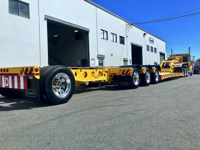 Yellow 60 ton lowbed with black fenders and a pin-on booster at the Pacesetter yard, photo 8 of 11
