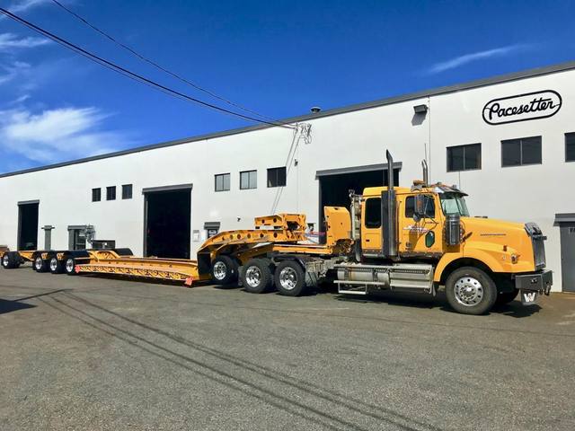 Yellow 60 ton lowbed with black fenders and a pin-on booster at the Pacesetter yard, photo 10 of 11