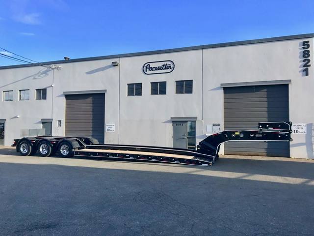 Black 65 ton lowbed with full fenders and white pinstripe edging on a sunny day, photo 1 of 7