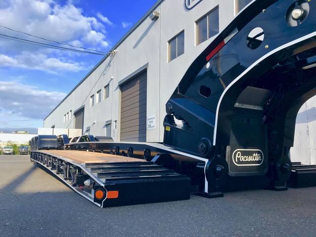 Black 65 ton lowbed with full fenders and white pinstripe edging on a sunny day, photo 3 of 7