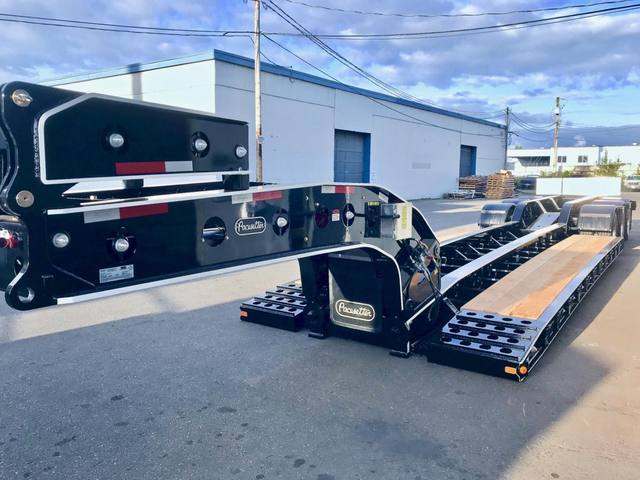 Black 65 ton lowbed with full fenders and white pinstripe edging on a sunny day, photo 7 of 7