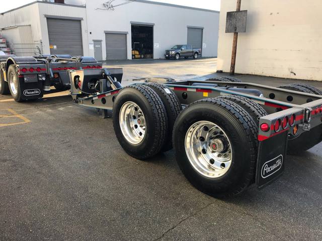 Charcoal 75 ton lowbed with light blue pinstriping and its two axle nitrogen booster, photo 23 of 26